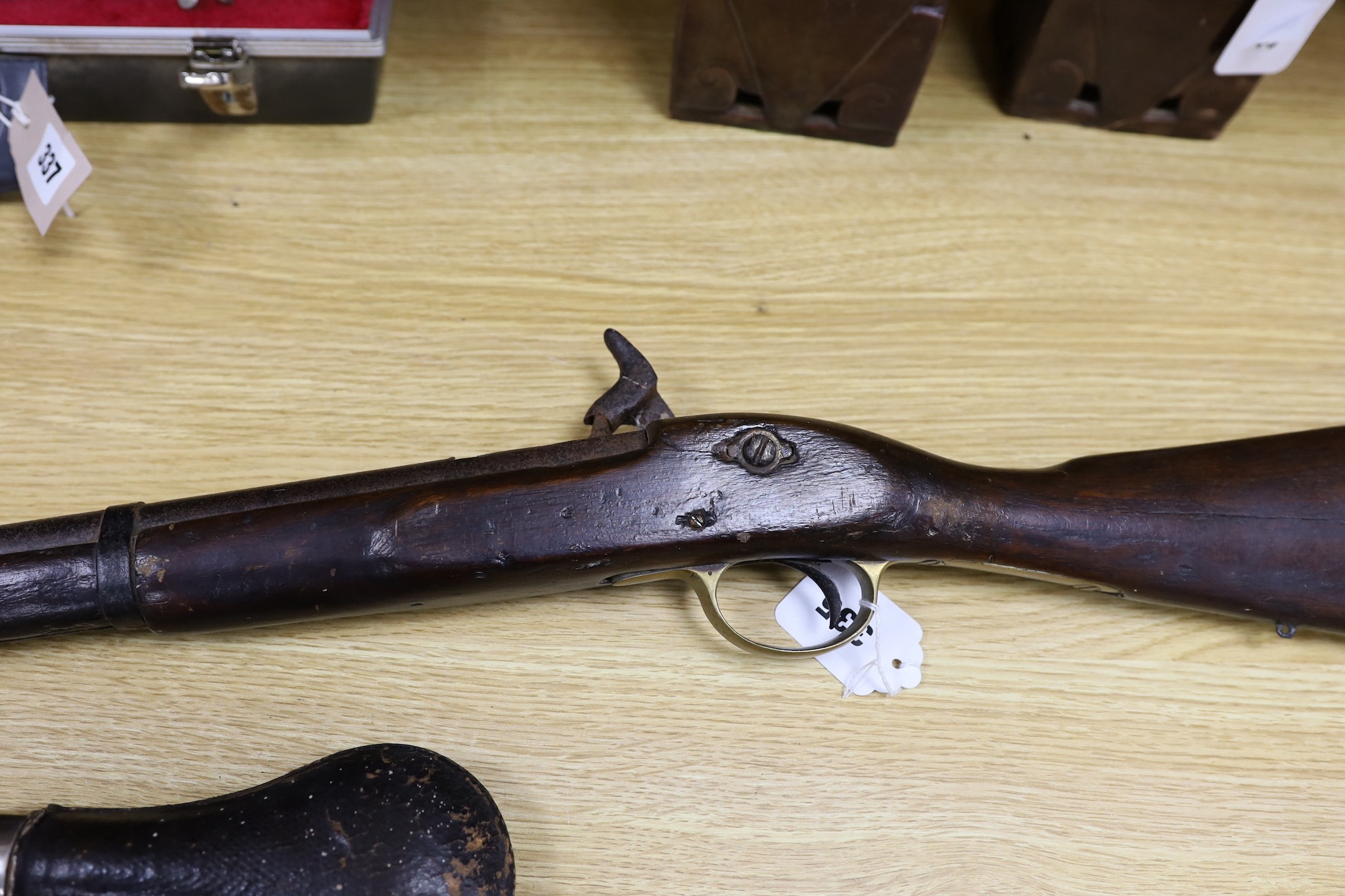 A 19th century percussion cap carbine musket with name stamped to lock plate and a shot flask, musket 94cms long